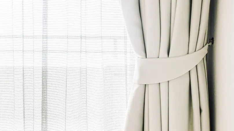 White curtains next to a window